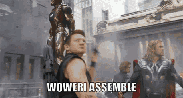 a man holding a statue with the words woweri assemble behind him