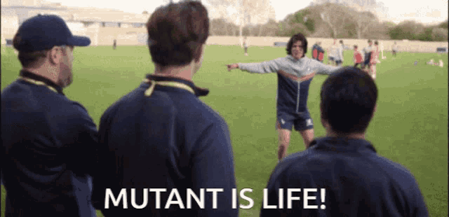 a group of men standing on a field with the words mutant is life written on the bottom