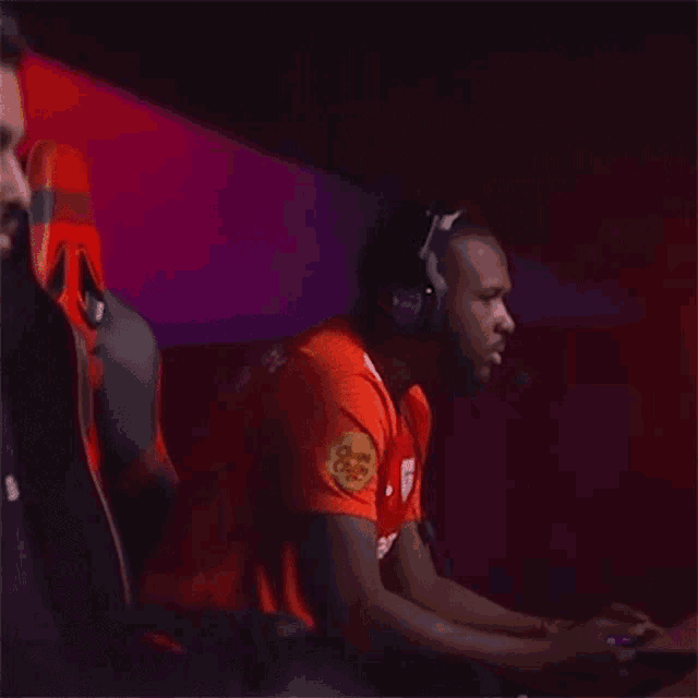 a man wearing headphones and a chupa chups shirt