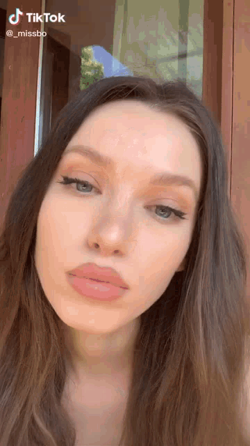 a close up of a woman 's face with the hashtag tiktok
