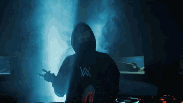 a man in a hoodie with the letter w on the back