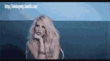 a woman with long blonde hair is standing in front of a blue background with the website http://aloboyetty.tumblr.com written on it