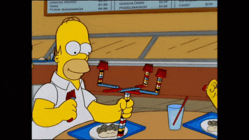 a cartoon of homer simpson sitting at a table with a plate of food