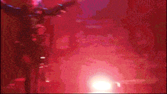 a blurry image of a person dancing in a red light