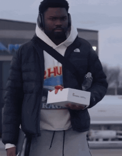 a man wearing headphones and a hoodie that says " chu " on it