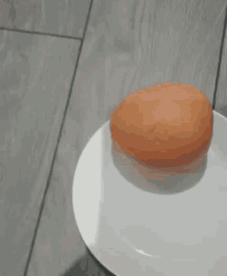 an orange is sitting on a white plate .