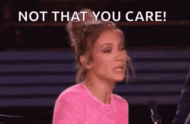 a woman in a pink shirt is sitting in front of a microphone and saying not that you care .