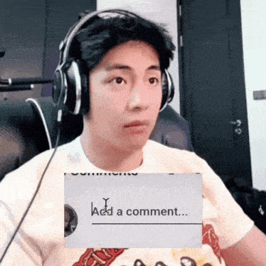 a man wearing headphones is looking at a sign that says " add a comment "