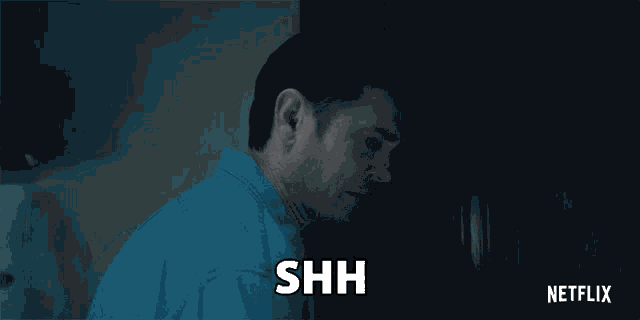 a man is holding his finger to his mouth and the word shh is above him