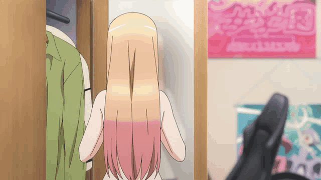 a girl with long blonde hair is standing in front of a wall with a poster that says ' aoi ' on it