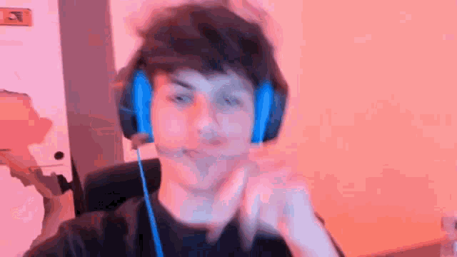 a young man wearing headphones and a microphone .