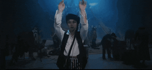 a man wearing a black hat and a white shirt is dancing