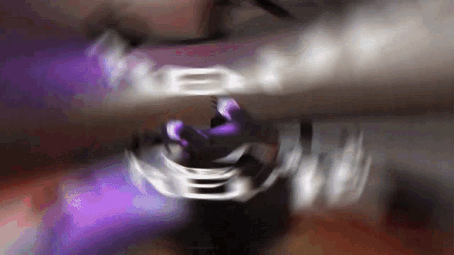 a blurry picture of a person 's face with a purple background .