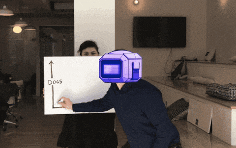a man holding a white board that says dogs