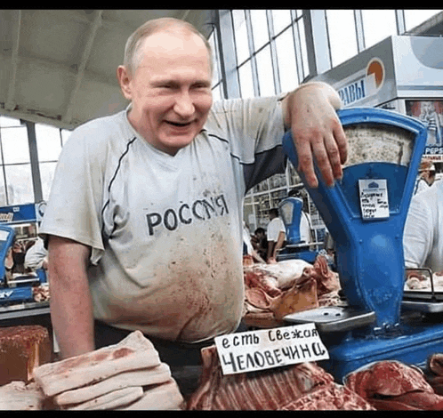 a man wearing a shirt that says ' russia ' on it stands in front of a scale