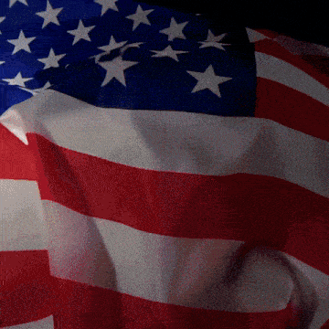an american flag is waving in the wind