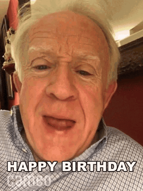 an elderly man is making a funny face and saying `` happy birthday '' .