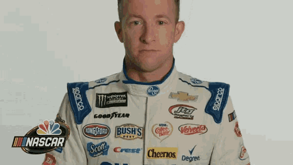 a man in a racing suit with logos for goodyear bush 's degree and cheerios