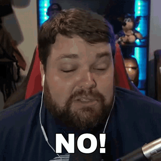 a man with a beard and ear buds says no
