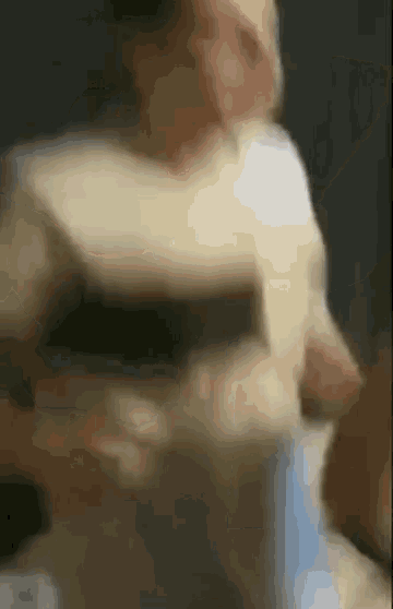 a blurry picture of a person standing in front of a box .