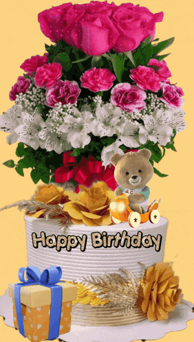 a birthday cake with flowers and a teddy bear on it
