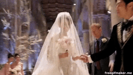 a bride and groom are holding hands during their wedding ceremony