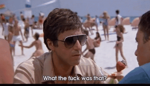 a man wearing sunglasses is talking to another man on a beach and says what the fuck was that