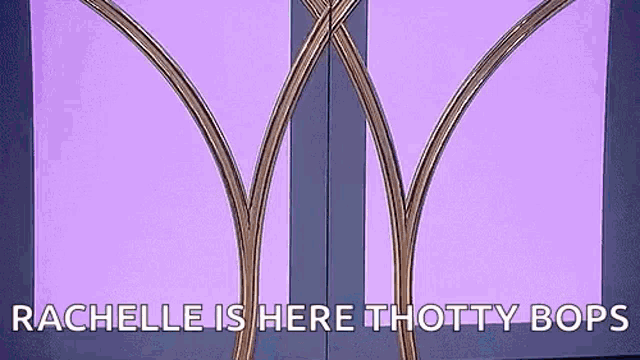 a woman in a fur coat is standing in a doorway with a purple background .