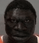 a close up of a man 's face in a jail cell with a blurred background .