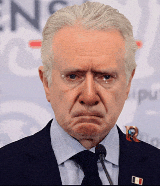 a man in a suit and tie is making a face
