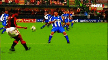 a group of soccer players are playing on a field with a amstel ad in the background