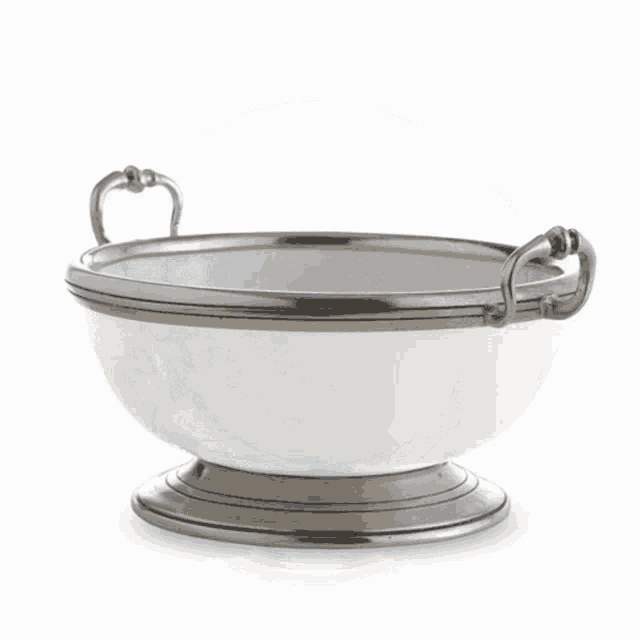 a silver pitcher with the letter e on the side