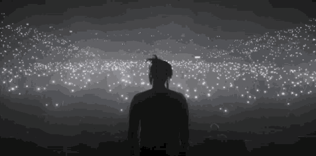 a man is standing in front of a crowd of people