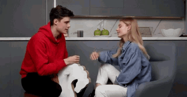 a man and a woman are sitting next to each other on a couch .