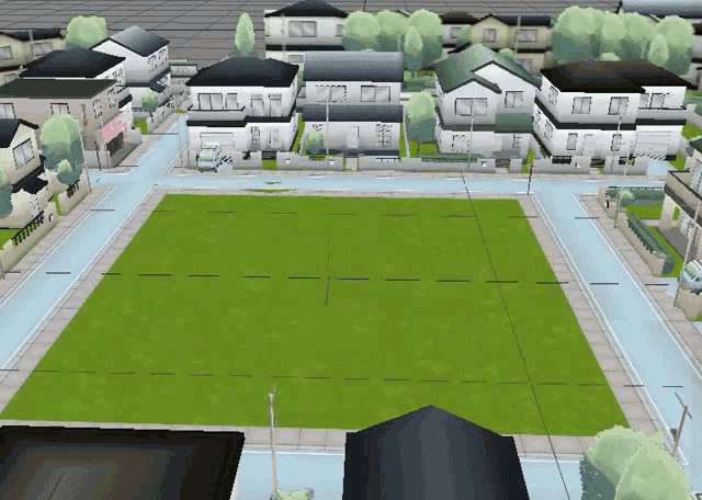 an aerial view of a residential area with houses and a green field in the middle