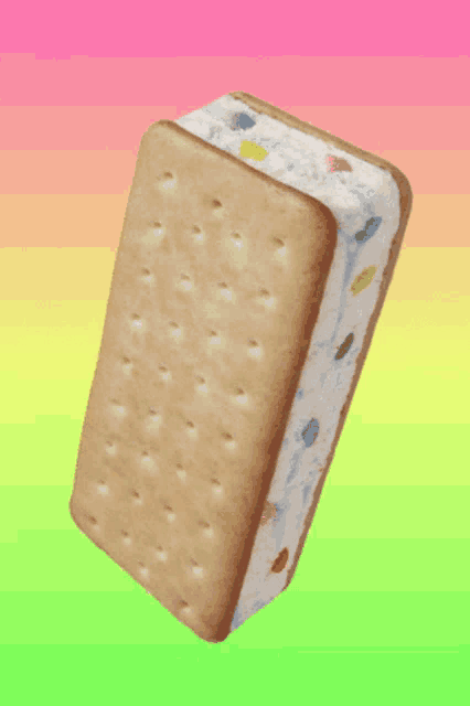 a biscuit sandwich with ice cream and candy sprinkles on a colorful background