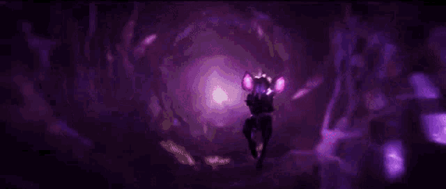 a person is standing in a dark room with a purple light coming out of their hands .