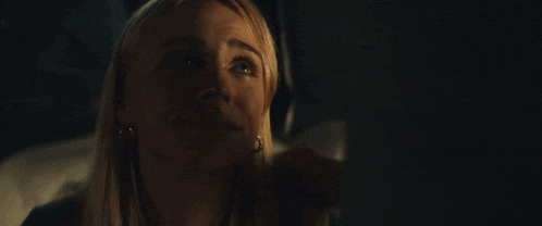a close up of a woman 's face with tears running down her cheeks