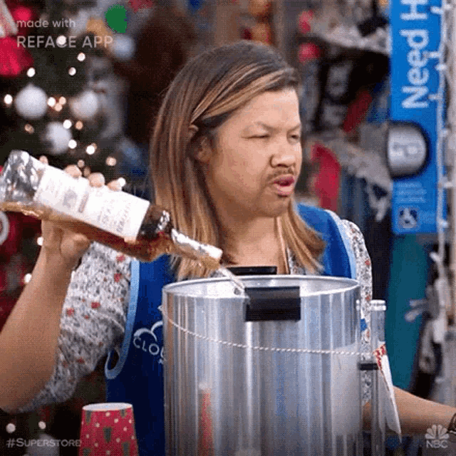 a woman is pouring a bottle of alcohol into a pot .