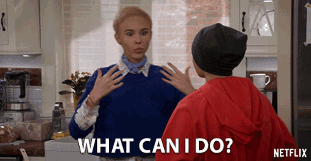 a woman in a blue sweater says what can i do next to a man in a red jacket