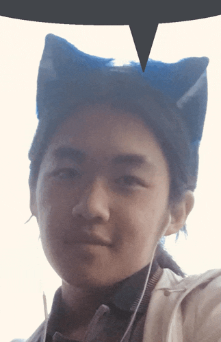a person wearing a cat ear headband with a speech bubble above them