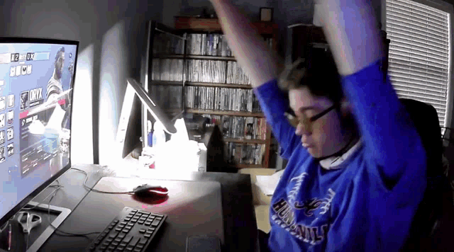 a person wearing a blue shirt that says ' houston ' on it is playing a video game