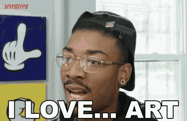 a man wearing glasses and a black hat says i love art