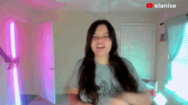 a woman in a room with a youtube logo on the bottom