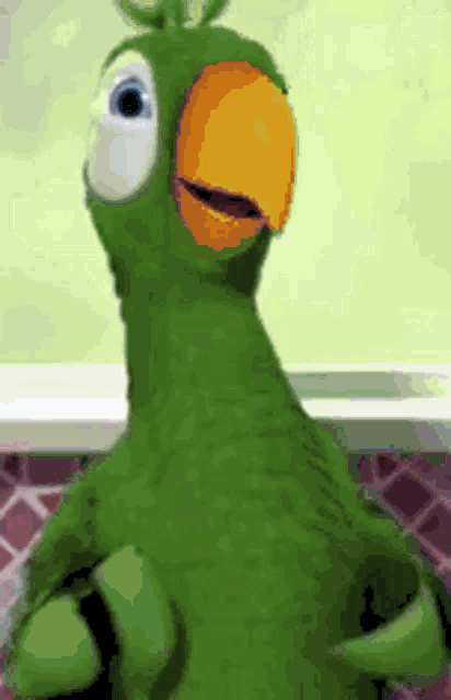 a green parrot with an orange beak is standing in front of a tiled wall .