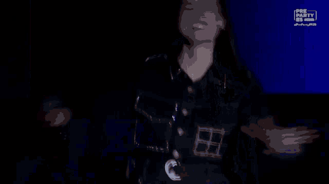 a woman in a police uniform holds a microphone in front of a red background that says pre party on it