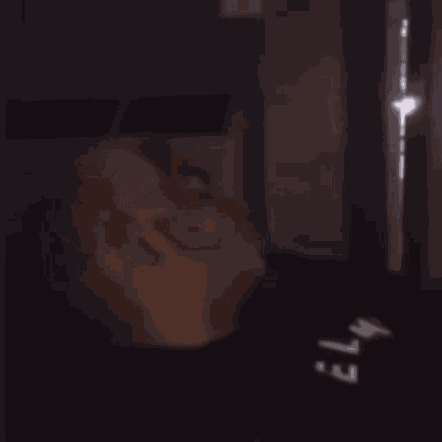 a blurry picture of a man covering his face with his hands