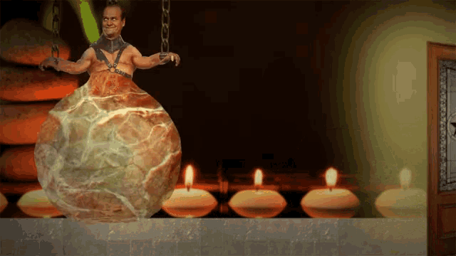 a man is chained to a large rock in a room with candles