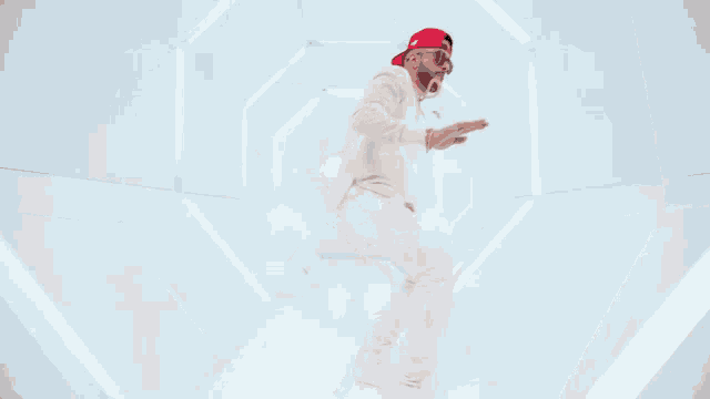 a man in a white suit and red hat is dancing .