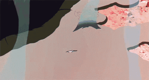 a close up of a person 's hand pointing at a piece of paper on the ground .